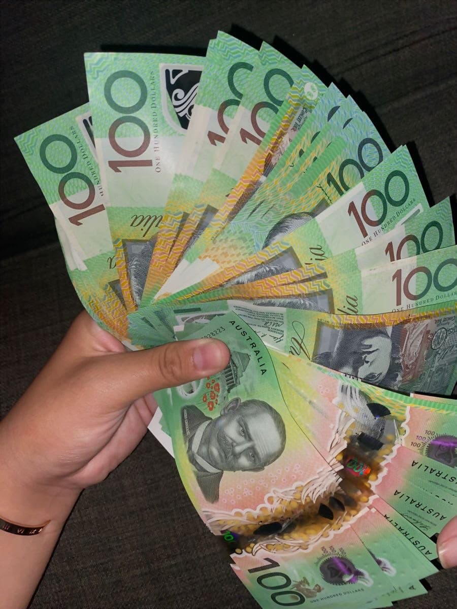 Lighting prop money for camera — fanned $100 specimen prop notes for glare-free filming