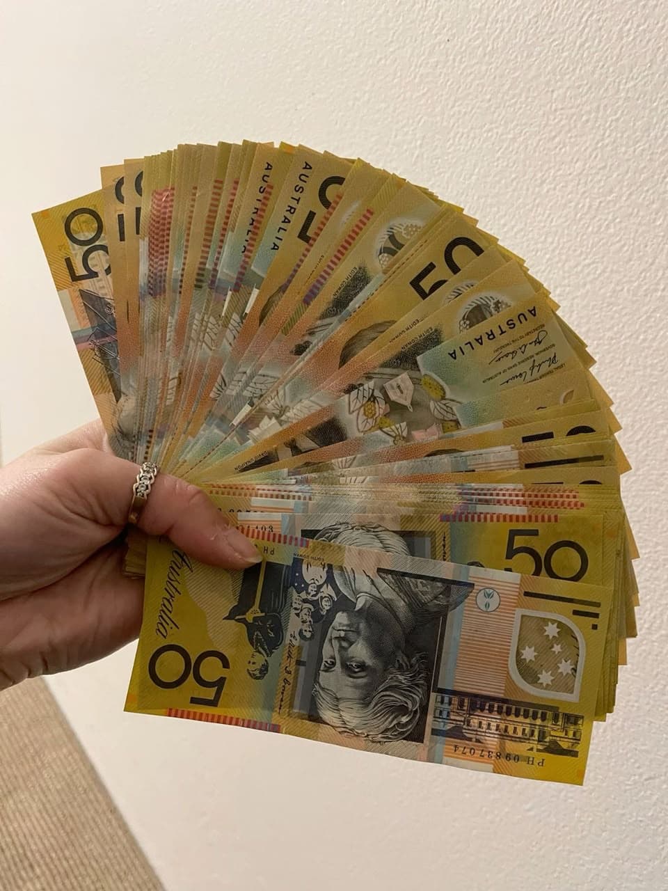 Fake australian money for content creators — handheld fan of $50 specimen prop notes