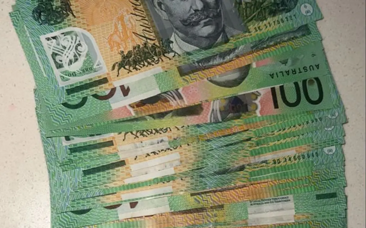 Fake money for classroom lessons: clearly marked play notes fanned in a hand for maths games