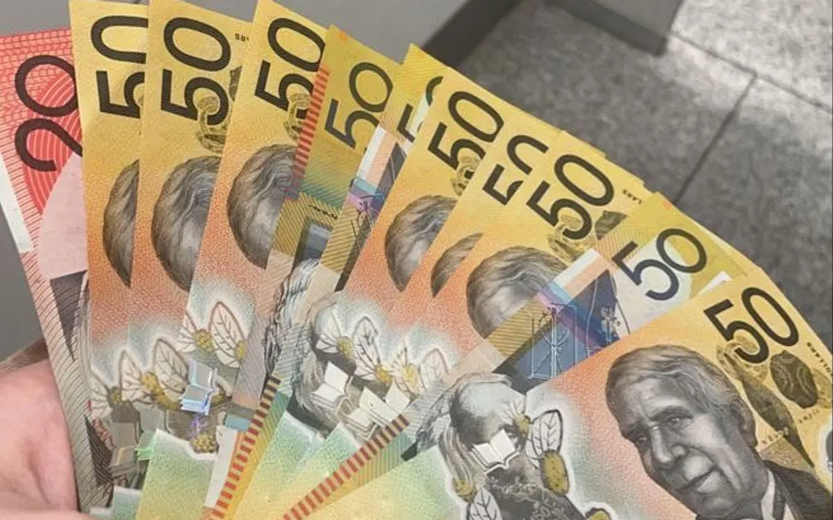 Monetary toys and play money: fanned $50 specimen notes held in a hand for pretend play