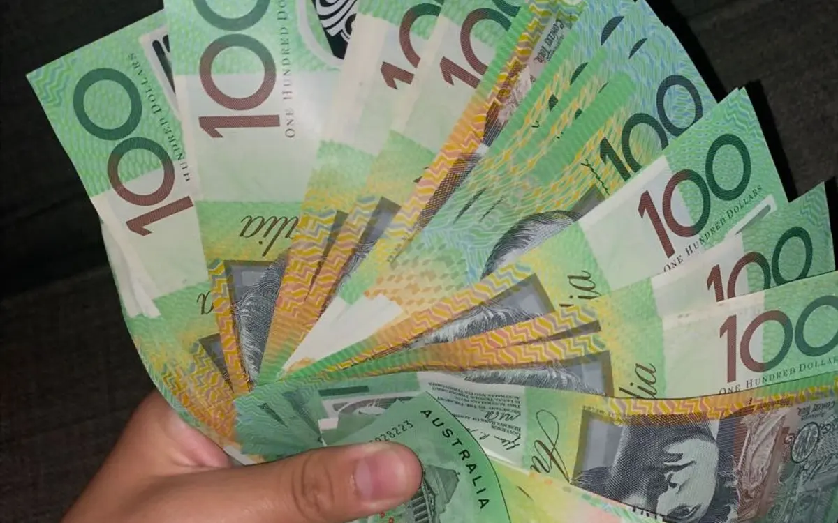 Prop money for music videos: fanned $100 specimen prop notes held in a hand